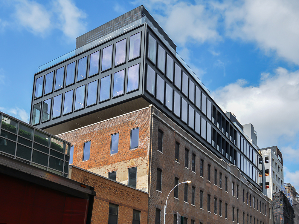 Designed by Morris Admi Architects, The Warehouse features a modern, three-story glass expansion atop a four-story brick base comprising a former industrial building in Manhattan’s Chelsea district. Elijah Equities developed the new Class A office property at 520 W. 20th St. Image courtesy of Noel Calingasan