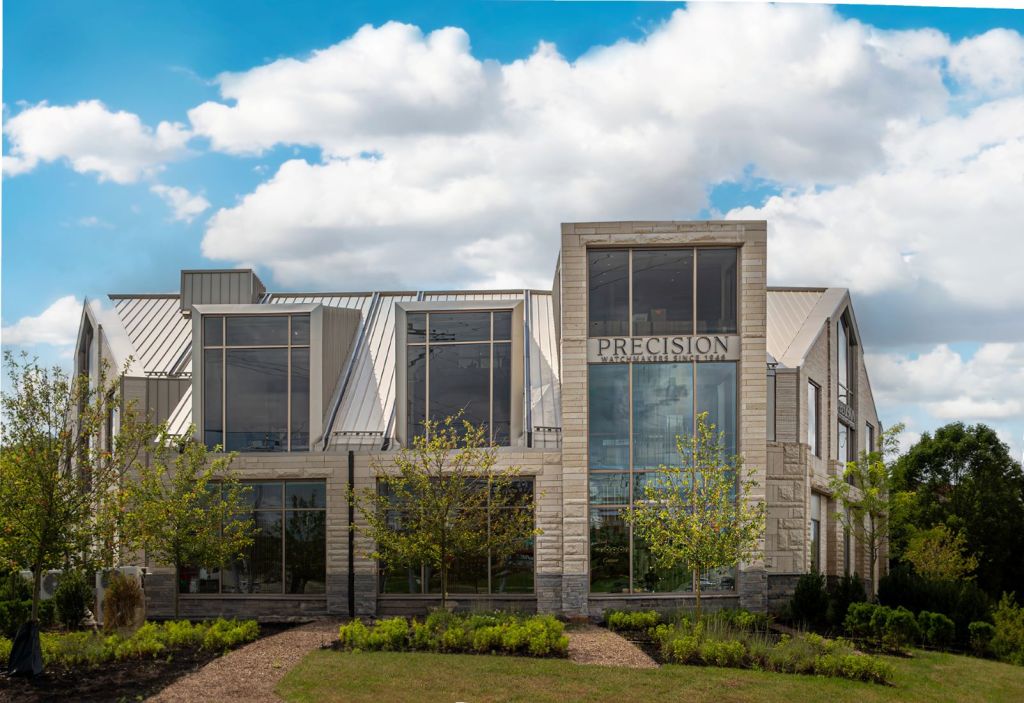 Exterior view of a new freestanding specialty center for retailer Precision Watches, clad in intricate Roman brickwork and tactile limestone.