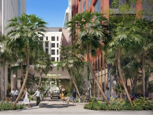 Exterior rendering of the Wynwood Plaza, a mixed-use development with glass and white and brown façade, surrounded by palm trees.