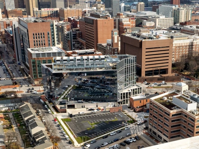 Aerial view of the first phase of 4MLK, an eight-story building with glass façade.