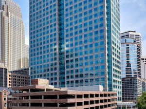 Exterior shot of Ameriprise Financial Center, a 31-story building with glass façade. The high-rise is surrounded by other office buildings.