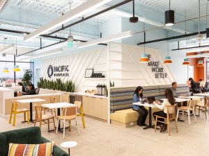 Interior shot of Pacific Workplaces' new, 13,000-square-foot coworking location at 84 W Santa Clara St. in San Jose, Calif. The image features a shared lounge area with tables and chairs.