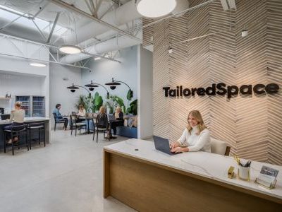 Interior shot of TailoredSpace's latest coworking space at 100 Avenida La Pata, Suite 200. The 10,500-square-foot flex office features a functional commercial space combined with a residential shared living room.