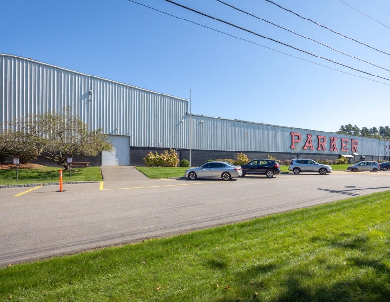 A large Class B industrial building with a robust exterior, featuring multiple windows and a prominent entrance.
