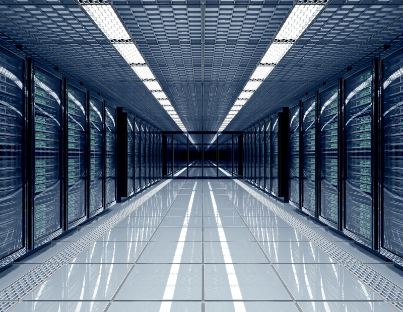 A long hallway lined with rows of servers, showcasing the organized layout of a modern data center.