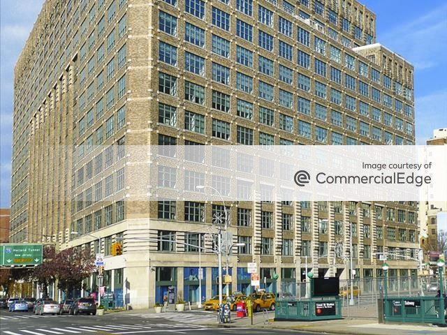 Exterior shot of 75 Varick Street, a 17-story office building with brown façade.