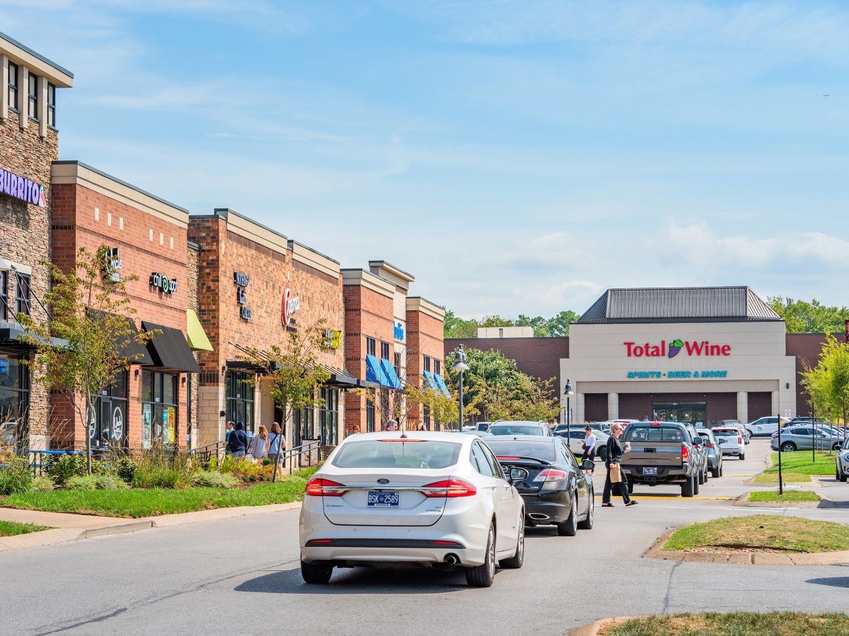 Exterior shot of several retail buildings at Brentwood Place Shopping Center in Brentwood, Tenn., with a Total Wine store in the background.